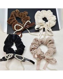 The pearl bow is wrapped around the large intestine hair tie and the fabric head is tied with a hair tie