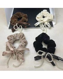 The pearl bow is wrapped around the large intestine hair tie and the fabric head is tied with a hair tie